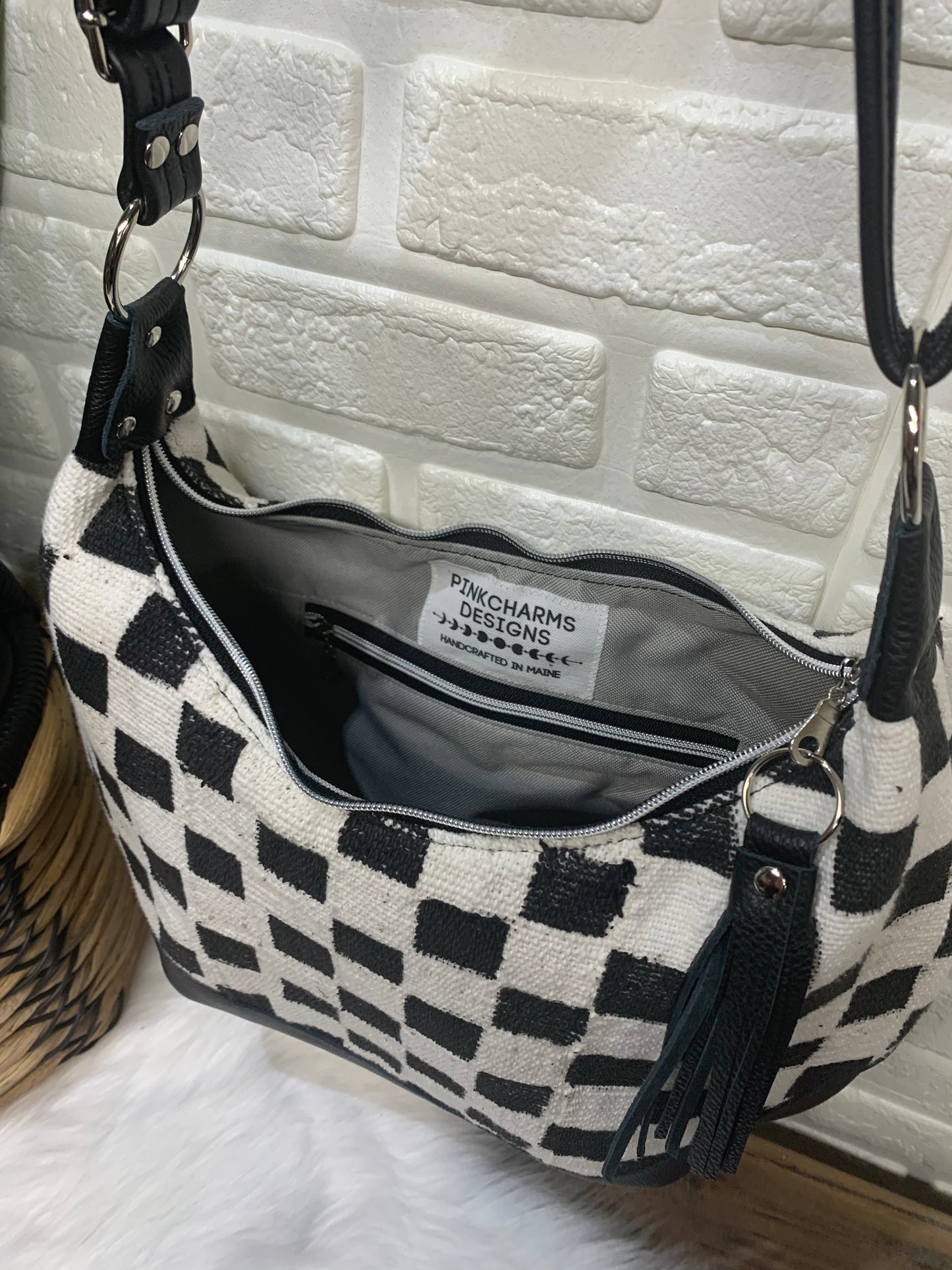 Checkered Mud Cloth and black leather hobo crossbody bag