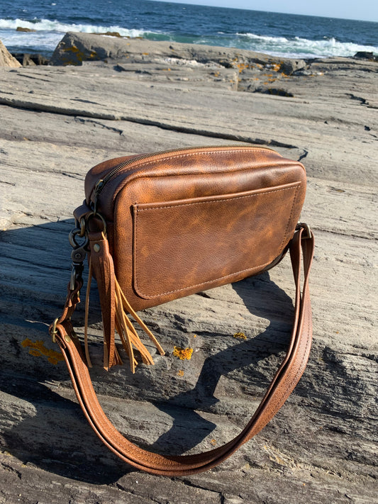 Square leather crossbody bag with front slip pocket, adjustable crossbody strap, gussets zipper panel